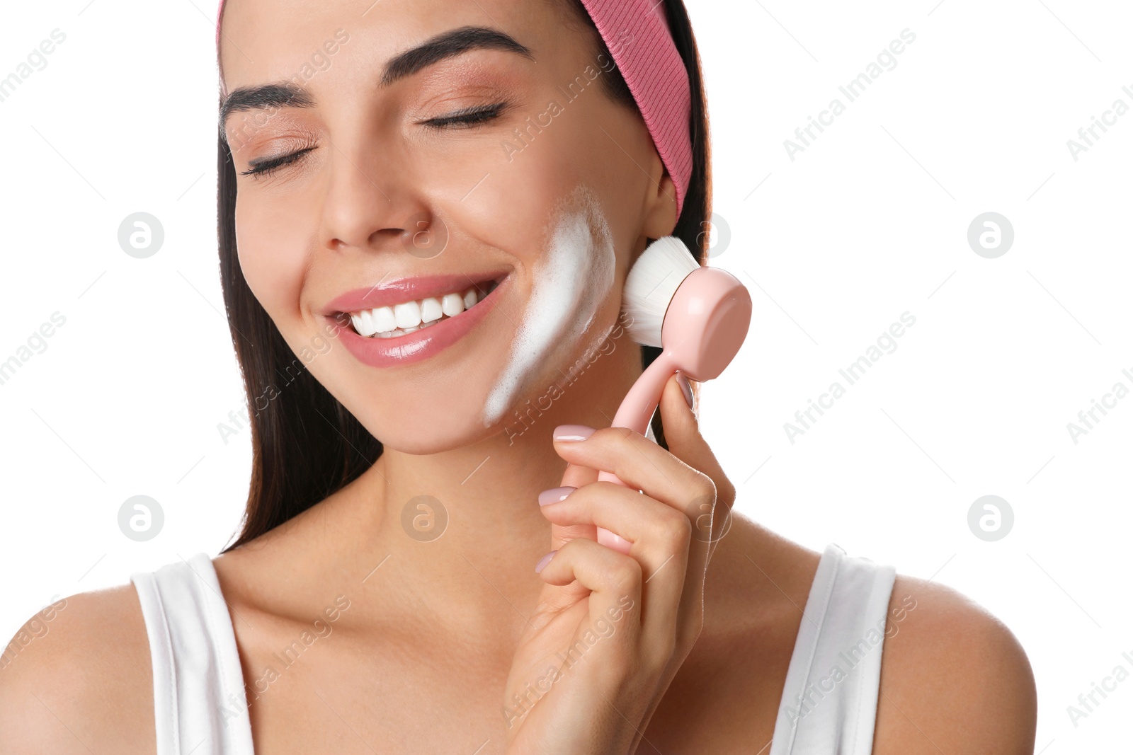 Photo of Young woman using facial cleansing brush on white background, closeup. Washing accessory