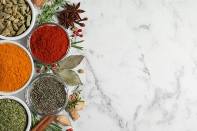 Photo of Flat lay composition with different natural spices and herbs on white marble table, space for text