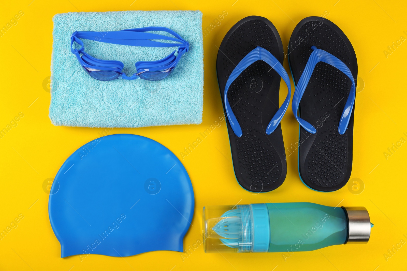 Photo of Flat lay composition with swimming accessories on yellow background