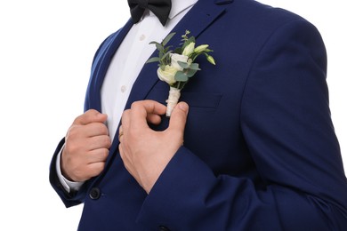 Groom with boutonniere on white background, closeup. Wedding accessory