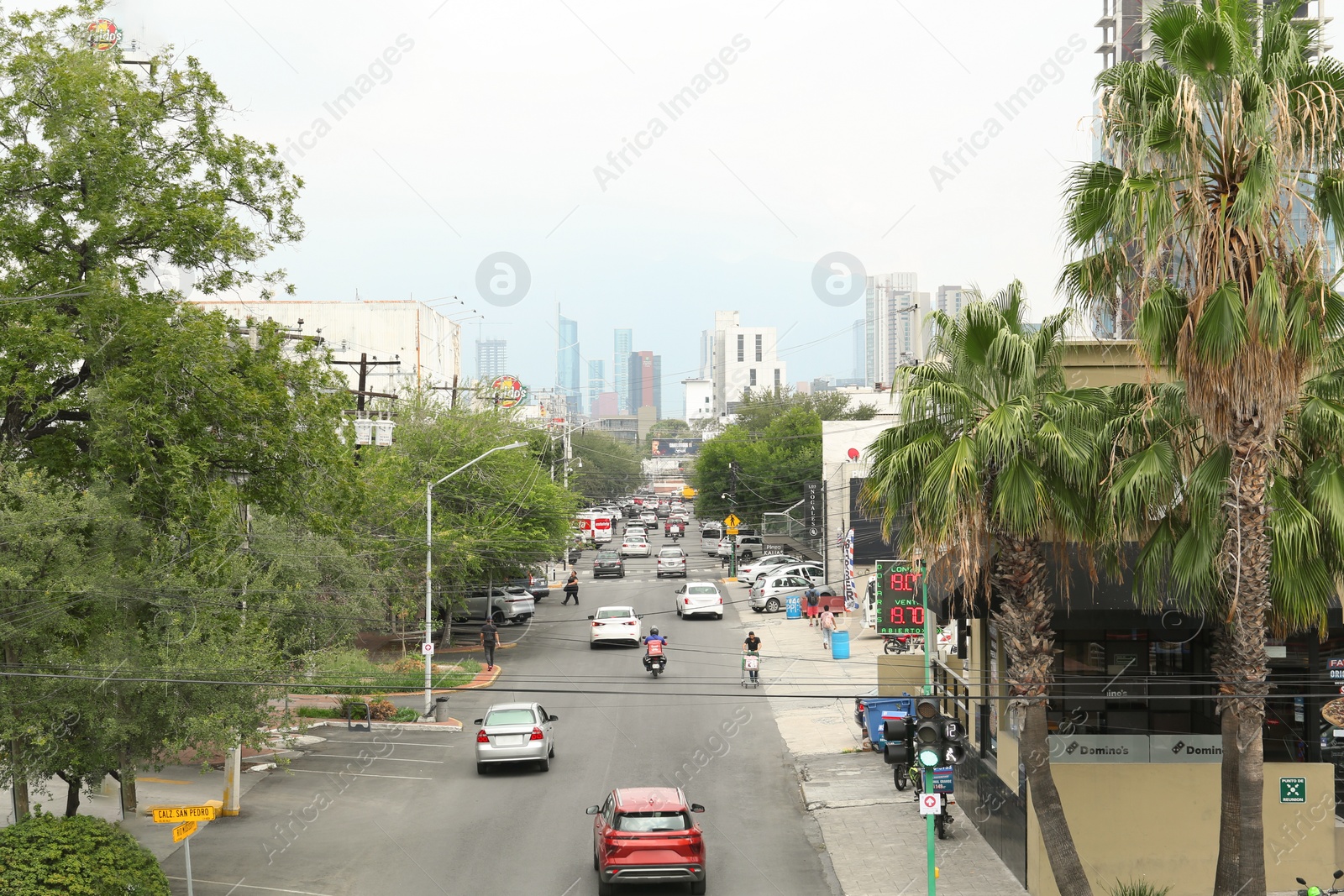 Photo of Mexico, San Pedro Garza Garcia - August 26, 2022: City street with modern cars, buildings and palms