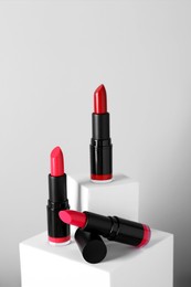 Photo of Different beautiful lipsticks on light gray background