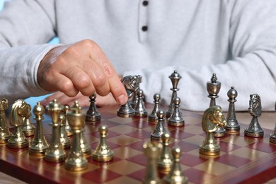 Photo of Man with knight playing chess at checkerboard, closeup