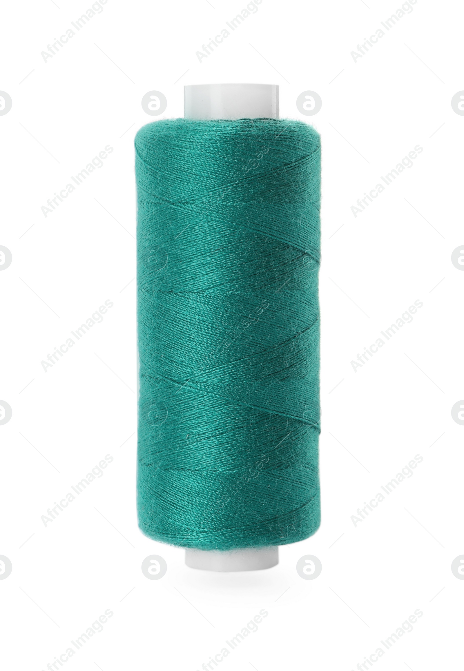 Photo of Spool of green sewing thread isolated on white