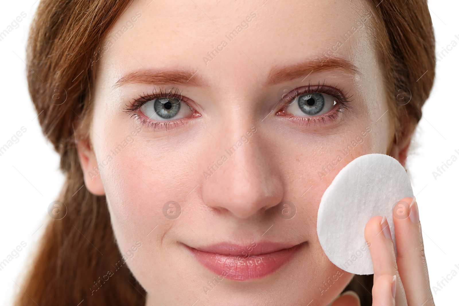 Photo of Beautiful woman with freckles wiping face on grey background, closeup