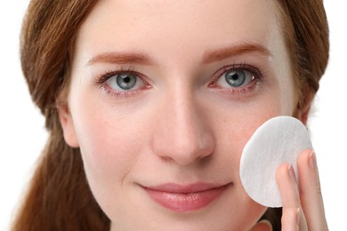 Beautiful woman with freckles wiping face on grey background, closeup