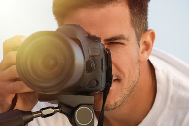 Image of Photographer taking picture with professional camera, closeup
