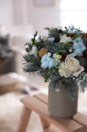 Photo of Beautiful wedding winter bouquet on wooden rack indoors