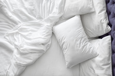 Comfortable bed with white linen at home