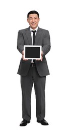 Businessman in suit showing tablet on white background