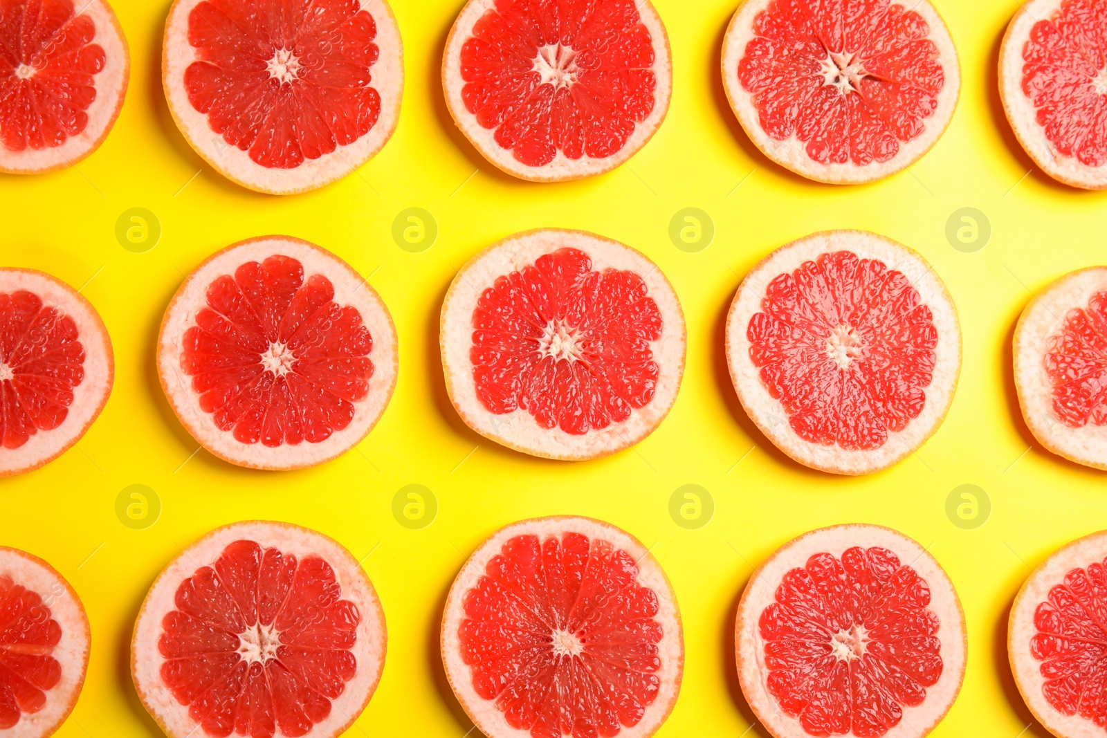 Photo of Fresh sliced ripe grapefruit on color background, flat lay