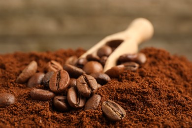 Photo of Ground coffee and scoop with roasted beans, closeup
