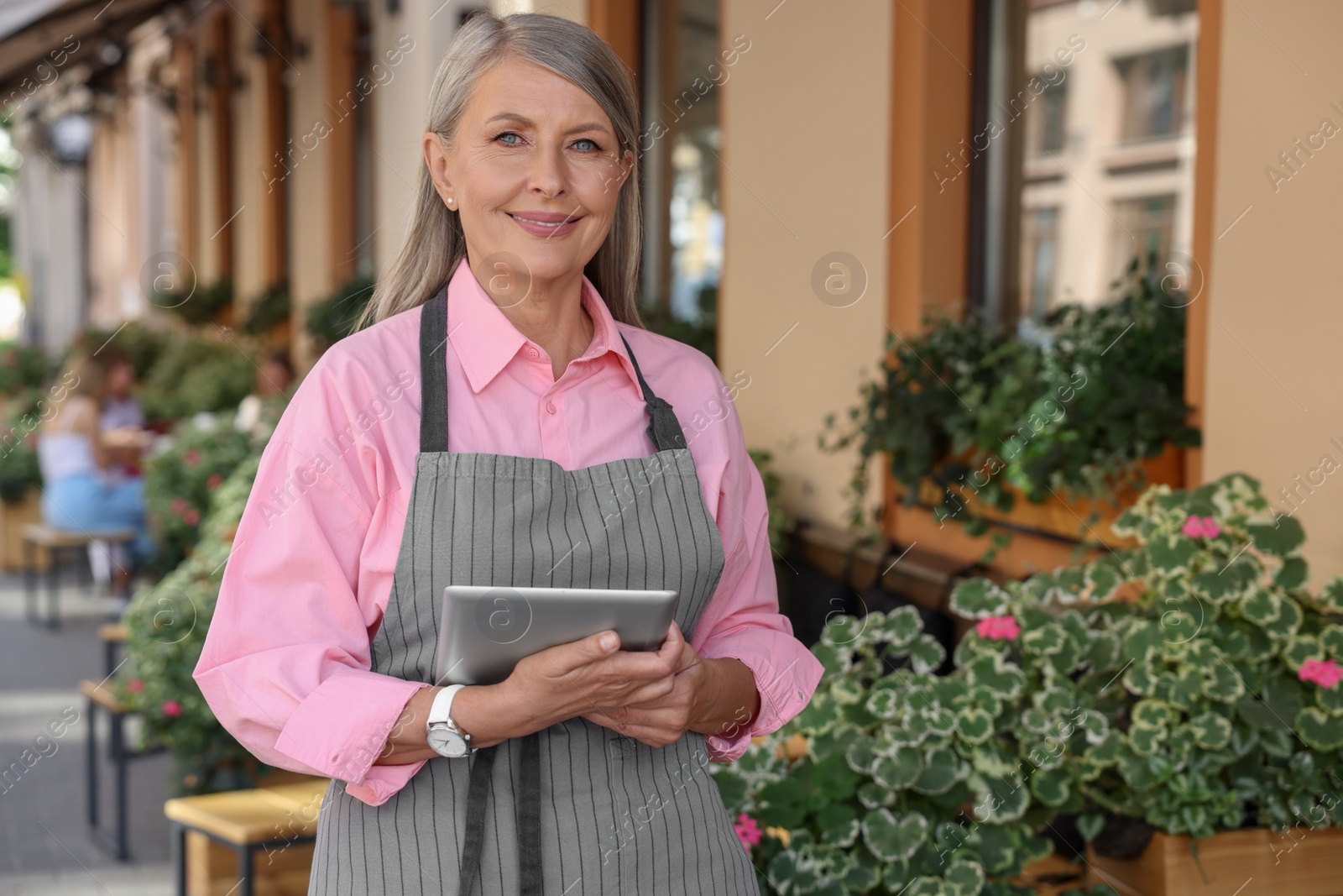 Photo of Happy business owner with tablet near her cafe outdoors, space for text