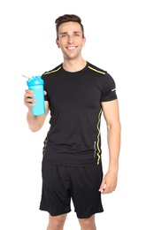 Portrait of man with bottle of protein shake on white background