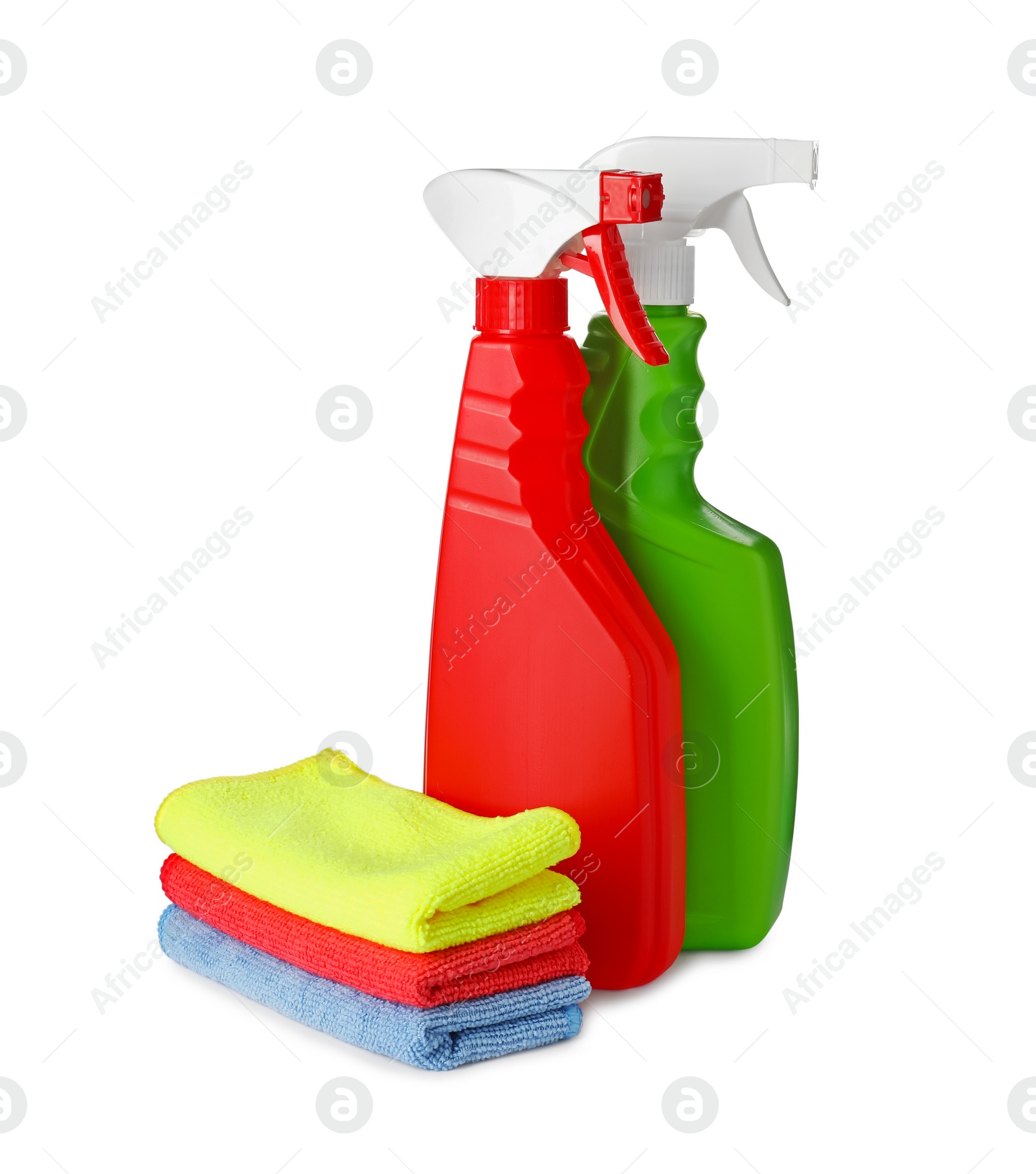 Photo of Spray bottles and stack of car wash cloths on white background