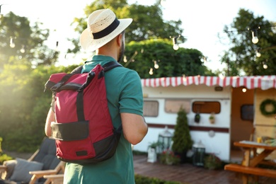 Photo of Young traveler with backpack outdoors. Summer trip