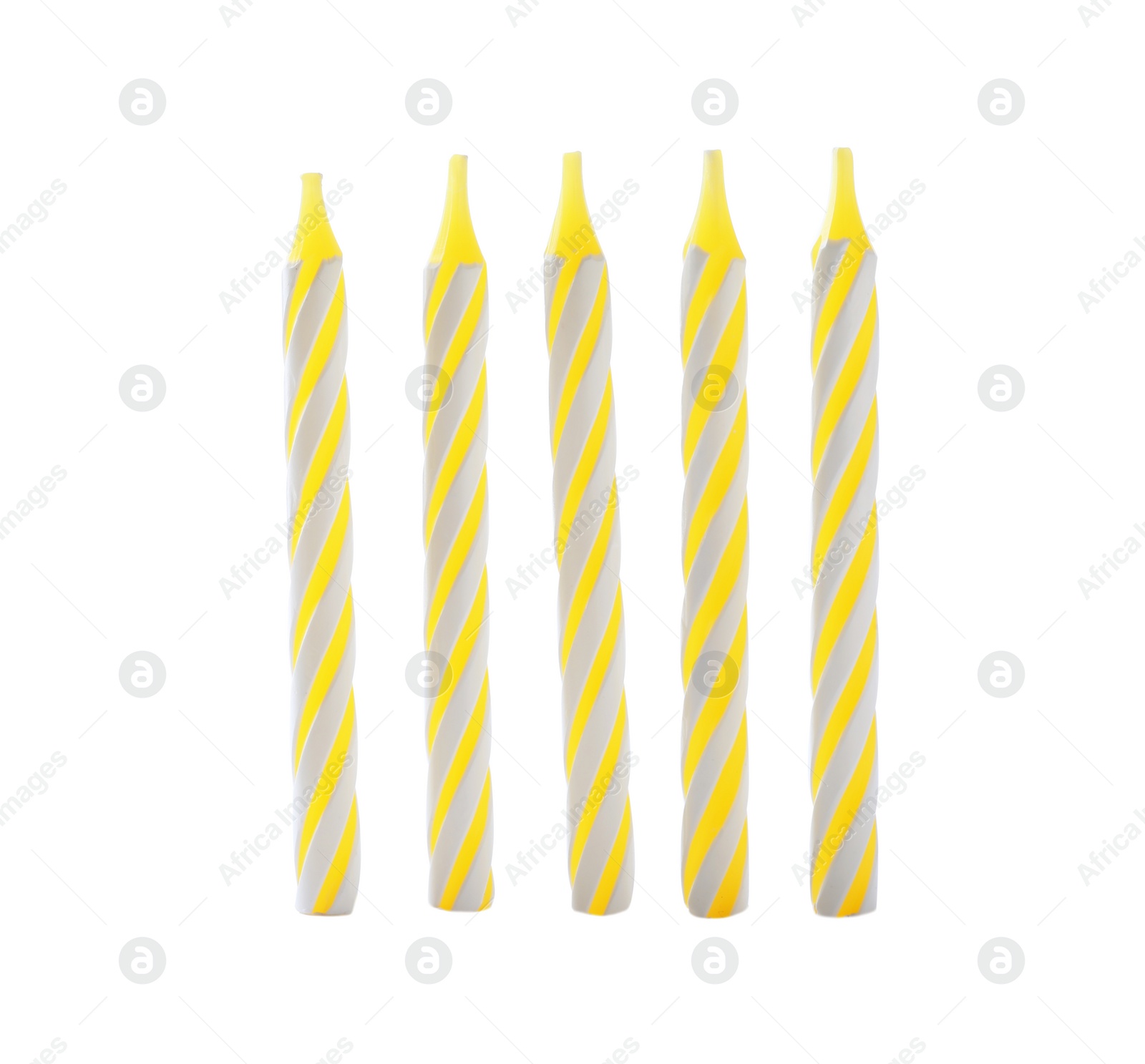 Photo of Yellow striped birthday candles isolated on white