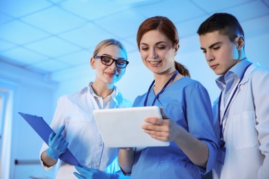 Group of scientists working in modern chemistry laboratory