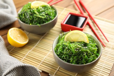Japanese seaweed salad served with soy sauce on table