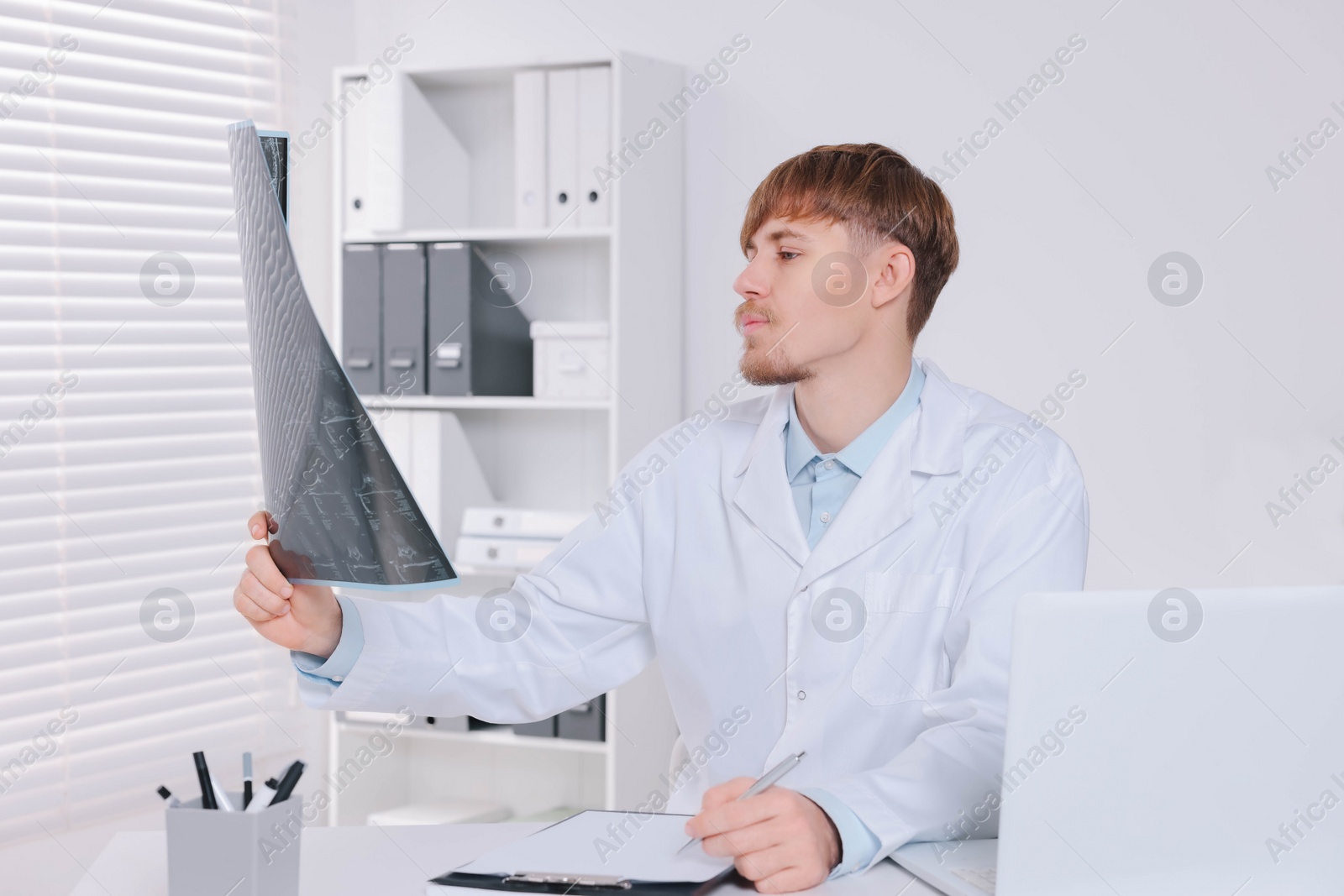 Photo of Doctor examining neck MRI image in clinic