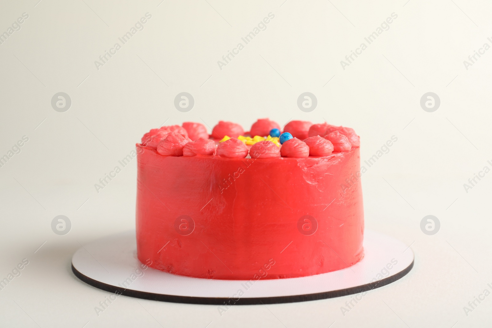 Photo of Cute bento cake with tasty cream on white background