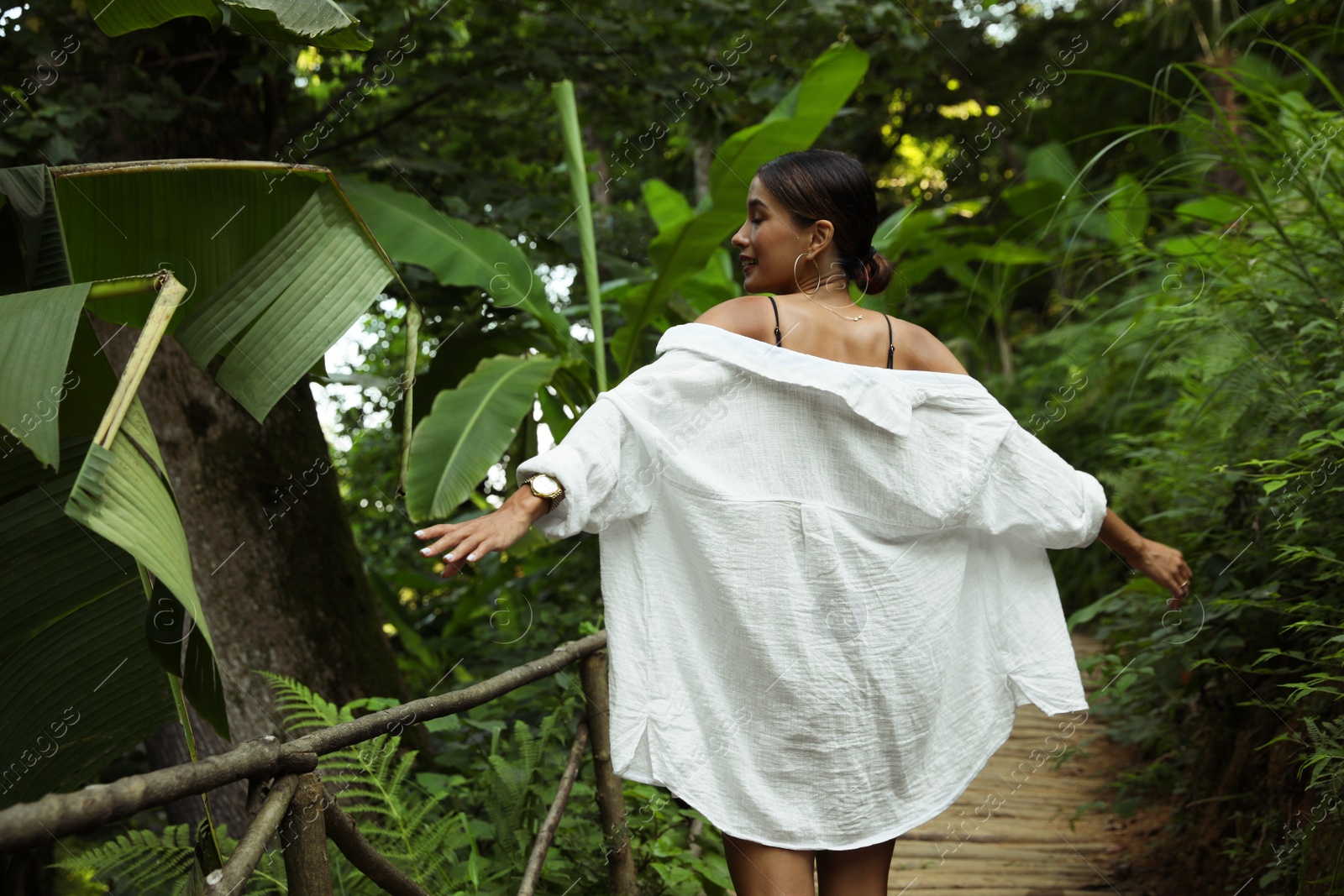 Photo of Beautiful young woman in green tropical park