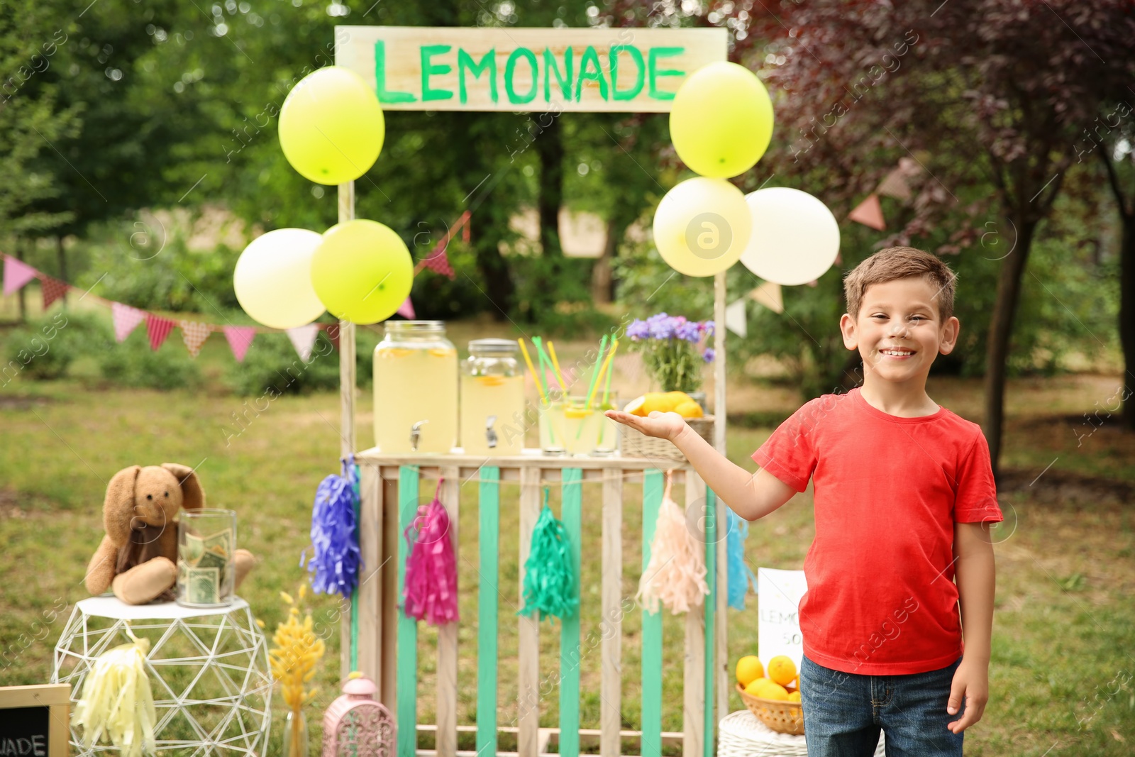 Photo of Little boy at lemonade stand in park