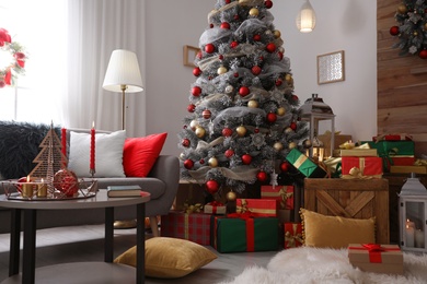 Image of Beautiful Christmas tree in living room. Festive interior