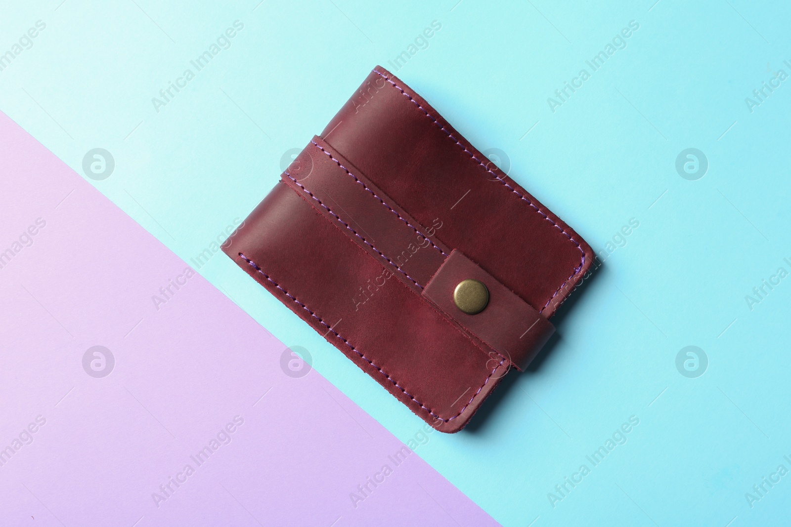 Photo of Stylish wallet on color background, top view