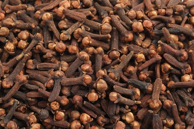 Aromatic dry cloves as background, top view