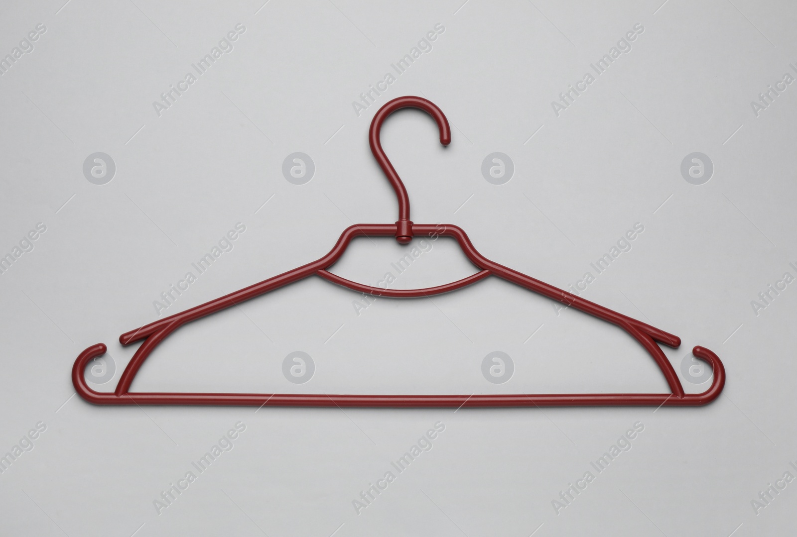 Photo of Empty clothes hanger on white background, top view