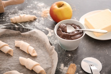 Photo of Composition with ingredients and raw croissants on table