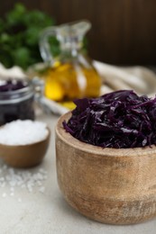 Tasty red cabbage sauerkraut and different ingredients on table