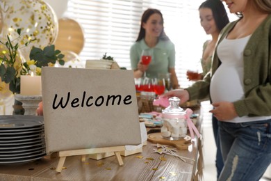 Photo of Pregnant woman and her friends taking delicious treats at baby shower party, closeup