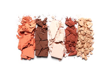 Photo of Crushed eye shadows on white background, top view. Professional makeup product