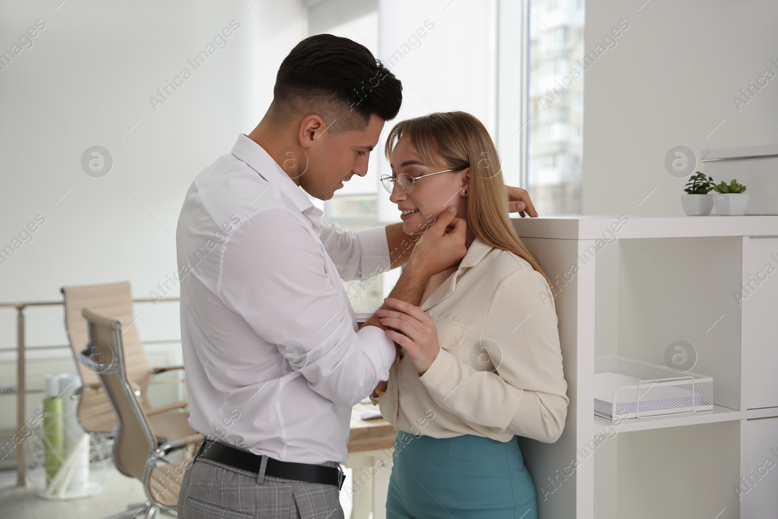 Photo of Colleagues flirting with each other in office