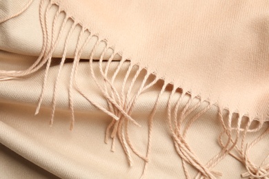 Beige soft cashmere scarf as background, closeup