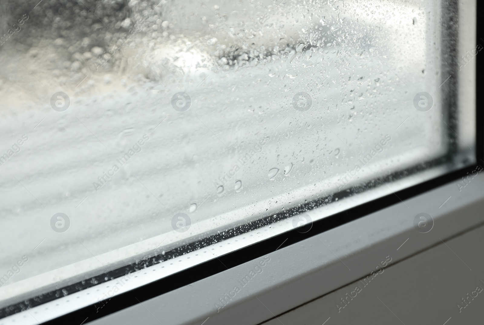 Photo of Window glass with drops of condensate indoors, closeup