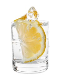 Photo of Vodka splashing out of shot glass with lemon on white background
