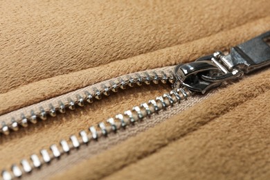 Photo of Beige jacket with zipper as background, closeup view