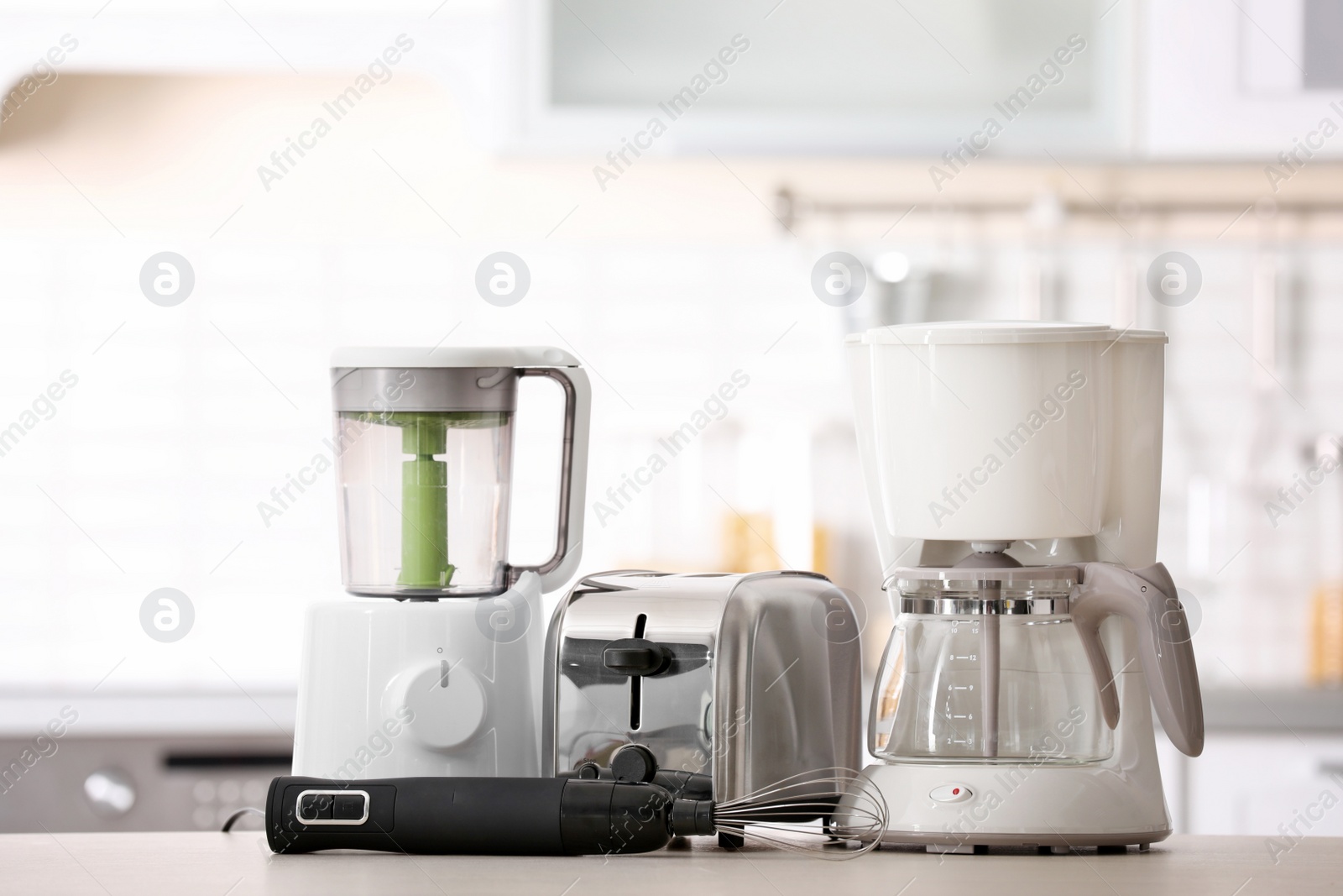 Photo of Kitchen appliances on table against blurred background