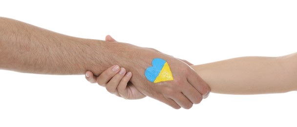 Photo of Man and woman with painted heart in colors of Ukrainian flag on her hand against white background, closeup