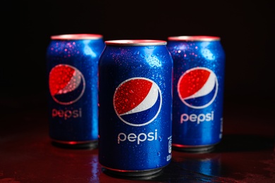 Photo of MYKOLAIV, UKRAINE - FEBRUARY 08, 2021: Cans of Pepsi with water drops on color background