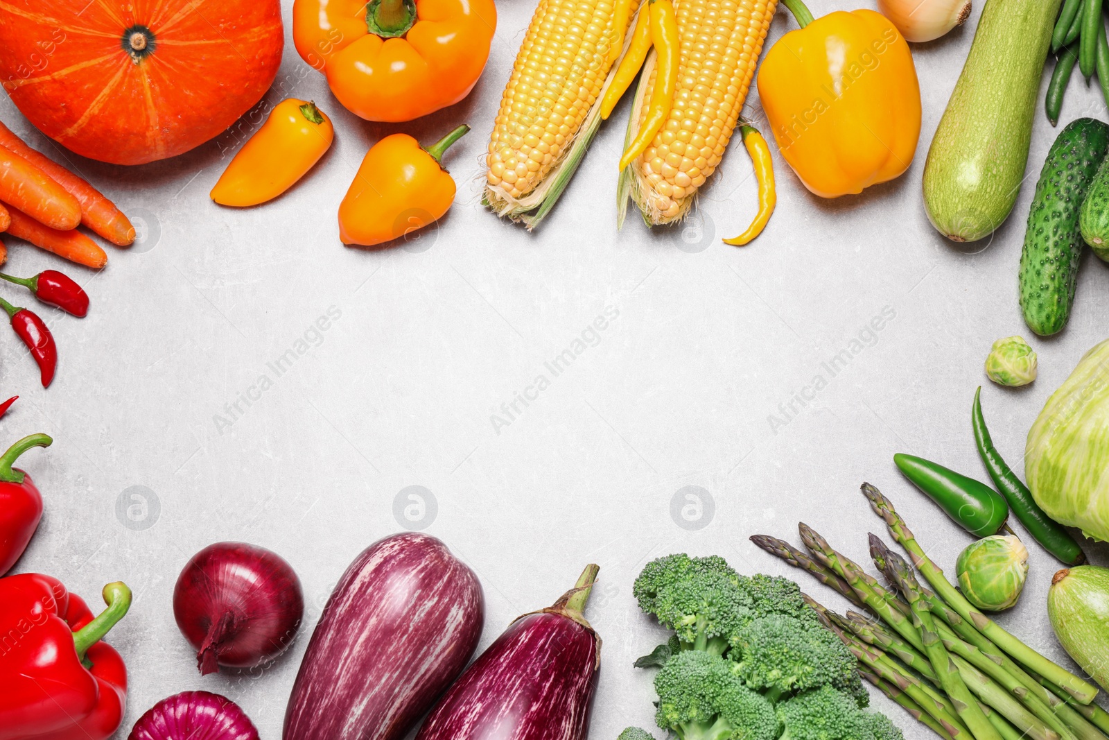 Photo of Frame of different fresh vegetables on grey table, flat lay. Space for text