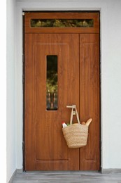 Photo of Helping neighbours. Bag of products hanging on door outdoors