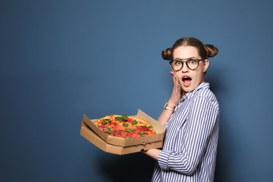 Photo of Attractive young woman with delicious pizza on color background