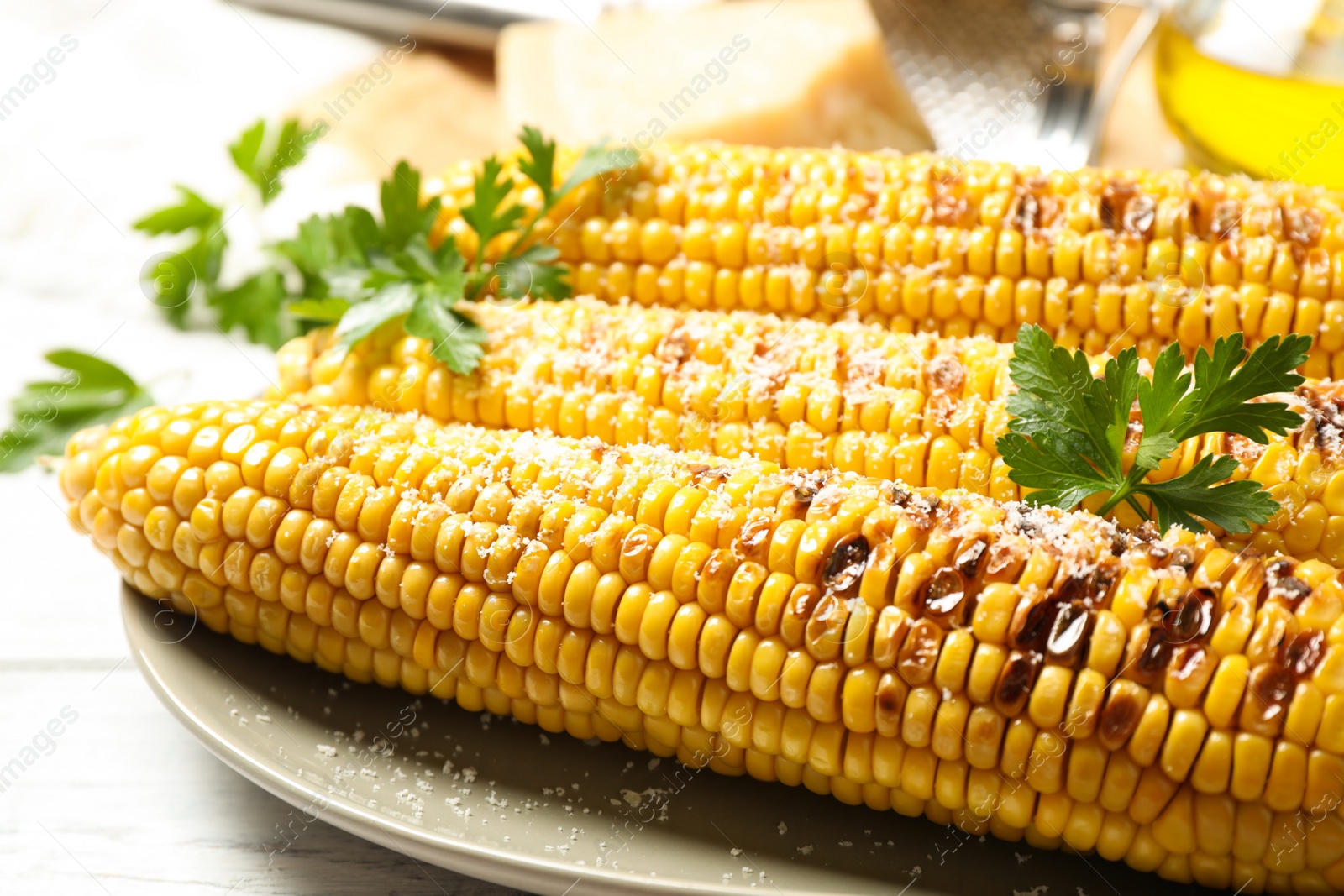 Photo of Tasty grilled corn with parmesan, closeup view