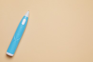 Stylish 3D pen on beige background, top view. Space for text