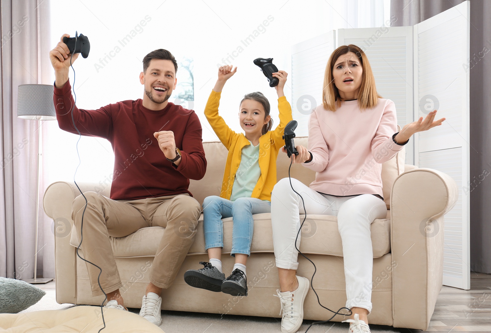 Photo of Happy family playing video games in living room