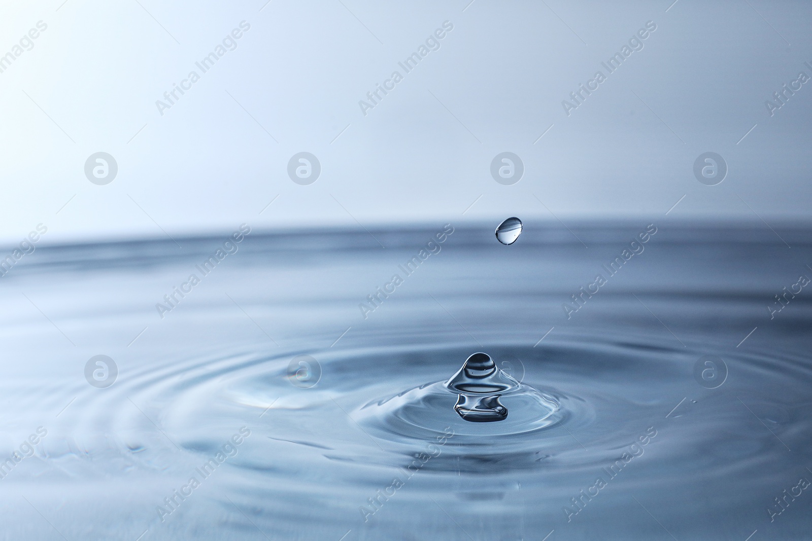 Photo of Splash of clear water with drop, closeup